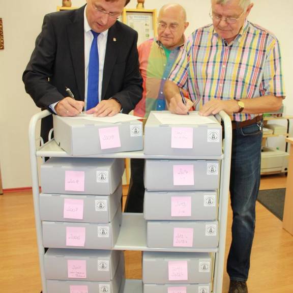 Die Unterzeichnung der Schenkungsurkunde durch Oberbürgermeister Jens Bühligen (l.) und Dr. Günther Hannuschka (r.), in der Mitte Horst Fischer unterzeichnung